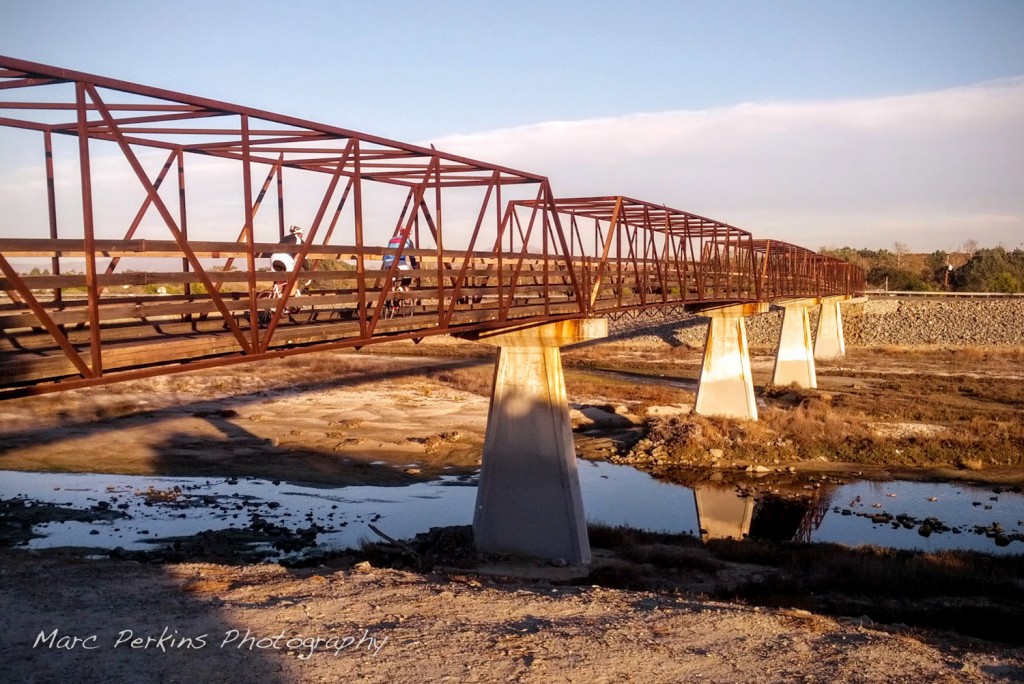 The bridge that connects the west and east side of the Santa Ana River Trail in Costa Mesa / Huntington Beach. North of this point SART runs primarily on the east side of the river; south of this point SART runs primarily on the west side of the river.