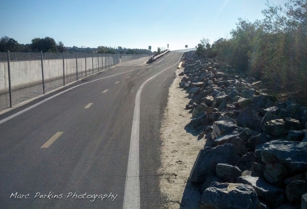 The exit to Fairview Park is just down a little slope from the fork that exits to Adams Ave. The Santa Ana River Trail continues up the slope in this image; the Fairview Park exit continues on level ground to the left.