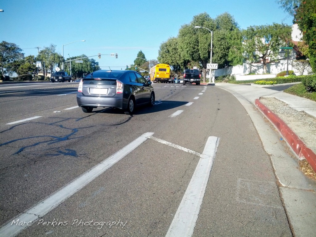 A protected bike lane ends abruptly and turns into a right-turn-only lane. Do you know if it's safe to move left so you can keep going straight? (this is the intersection of Placentia and Adams in Costa Mesa)