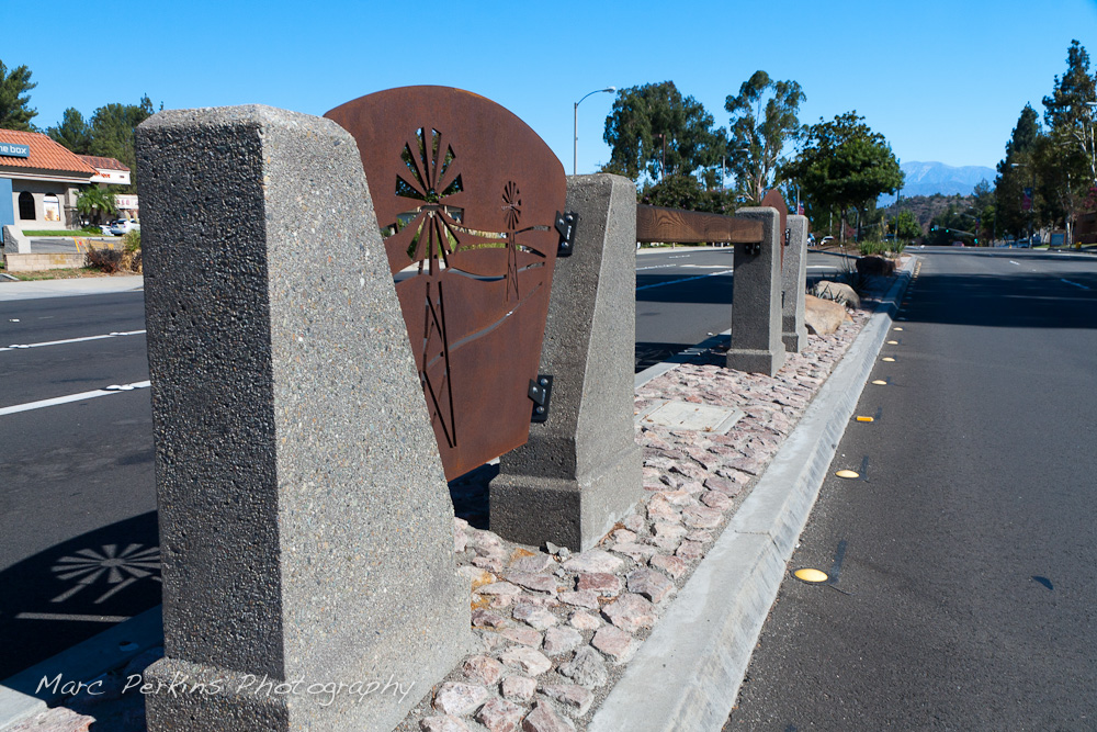 The rocks and iron plate windmilll cutouts of the northern median. This was part of the 2015 rebuild of the Grand Avenue and Diamond Bar Boulevard intersection for Diamond Bar's 2015 "Grand Avenue Beautification" project, landscape architecture for the project was by David Volz Design.