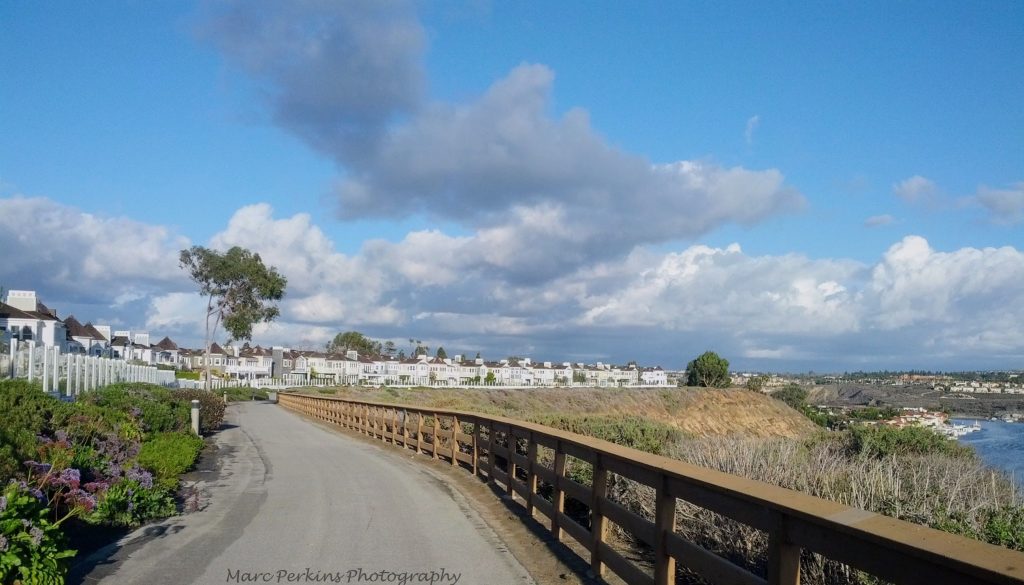 Bike trail on cliffs above water.