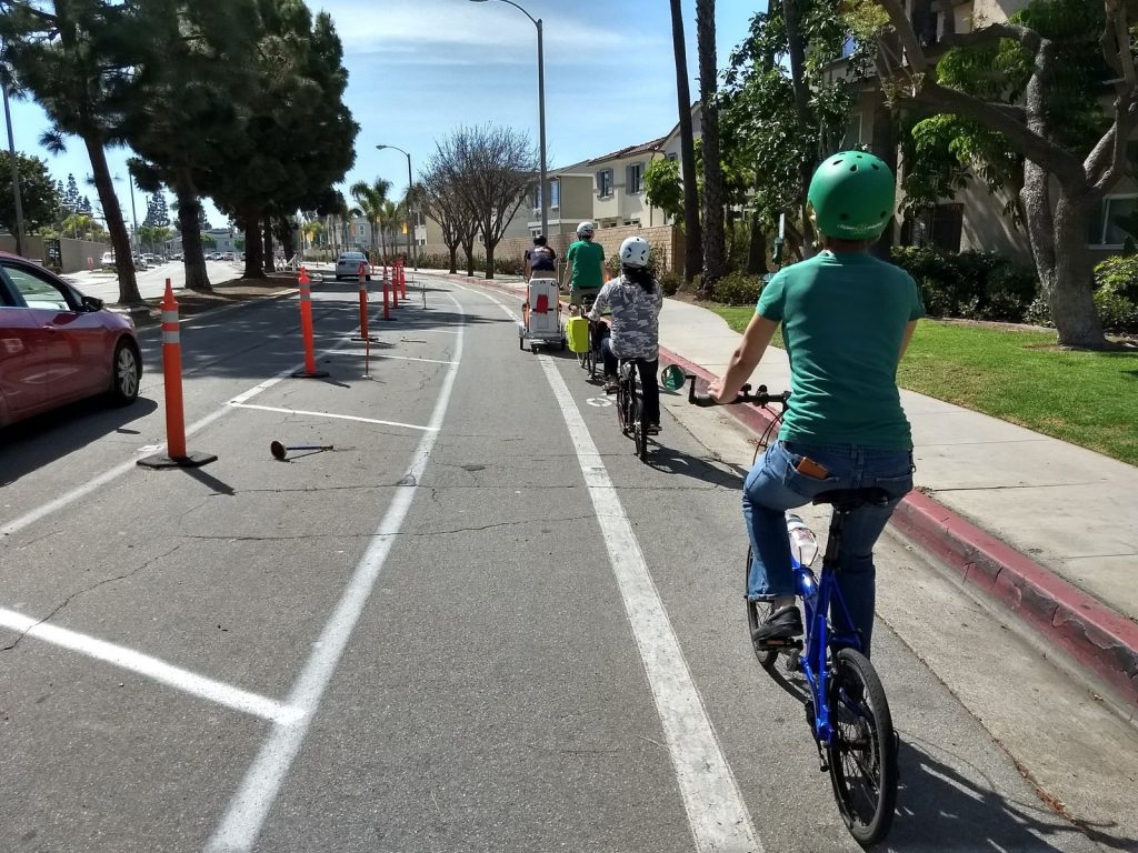 The OCC Food Riders travel down the demonstration protected bike lane on Merrimac Way.