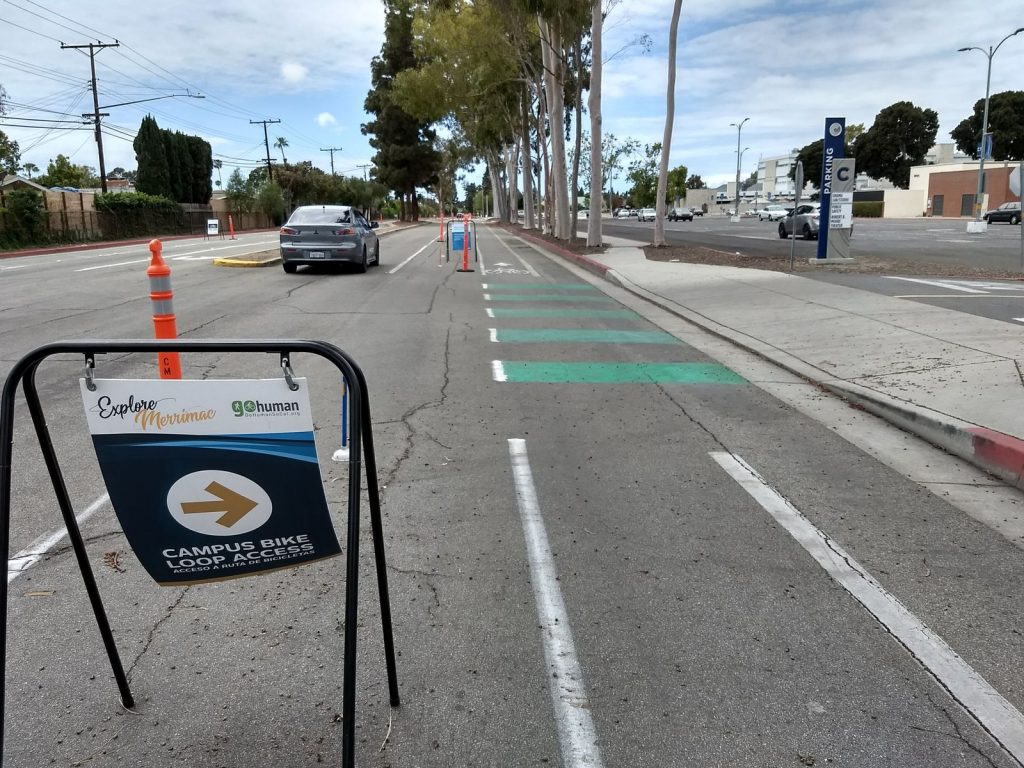 Conflict zone striping at a driveway along the Merrimac Way demonstration protected bike lane. 